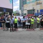 بالصور... وقفة لمكافحة عمالة الأطفال في الخليل